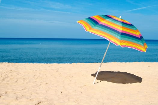 Beach umbrella on a sunny day, sea in background