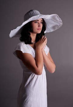 beautiful young fashion woman in white dress and hat