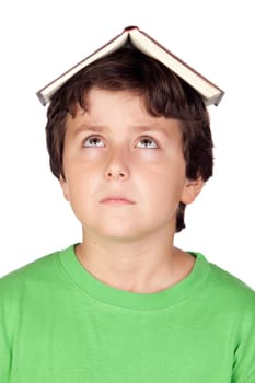 Student child with a book on his head isolated over white background