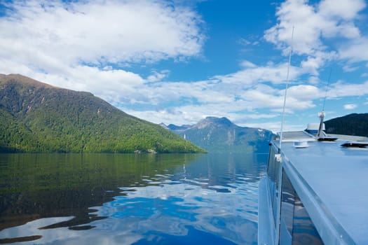 Boat traveling through Doubtful Sound in New Zealand