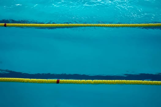 empty swimming pool detail, three swimming lanes divided with plastic barrier, photo taken in Humenné - Slovakia