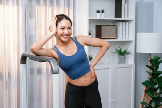 Asian woman in sportswear portrait, smiling and posing cheerful gesture. Home workout training or exercise fitness lifestyle. Attractive girl engage in her pursuit of healthy lifestyle. Vigorous