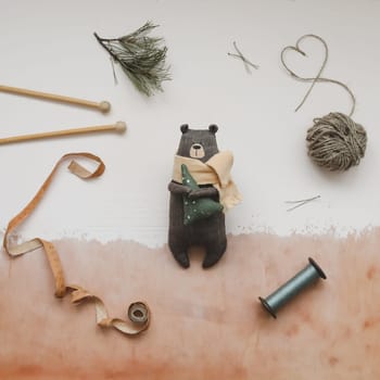 Christmas composition. Toy Teddy Bear, a gift, fir tree branches and decorations. Christmas, winter, new year concept. Flat lay, top view, copy space.