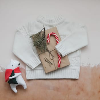 Christmas composition. Toy Teddy Bear, a gift, fir tree branches and decorations. Christmas, winter, new year concept. Flat lay, top view, copy space.