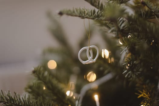 Christmas and New years eve Background. Close up of balls on christmas tree. Bokeh garlands in the background. New Year concept. Decorated Christmas tree on blurred, sparkling and fairy background