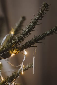 Christmas and New years eve Background. Close up of balls on christmas tree. Bokeh garlands in the background. New Year concept. Decorated Christmas tree on blurred, sparkling and fairy background