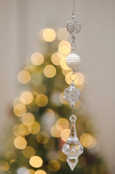 Christmas and New years eve Background. Close up of balls on christmas tree. Bokeh garlands in the background. New Year concept. Decorated Christmas tree on blurred, sparkling and fairy background