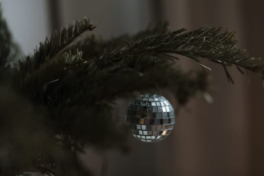 Christmas and New years eve Background. Close up of balls on christmas tree. Bokeh garlands in the background. New Year concept. Decorated Christmas tree on blurred, sparkling and fairy background