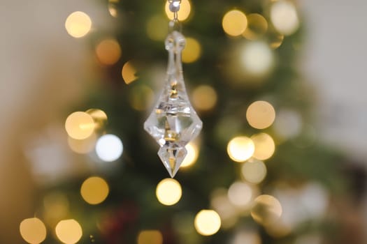 Christmas and New years eve Background. Close up of balls on christmas tree. Bokeh garlands in the background. New Year concept. Decorated Christmas tree on blurred, sparkling and fairy background