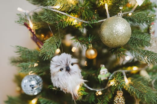 Christmas and New years eve Background. Close up of balls on christmas tree. Bokeh garlands in the background. New Year concept. Decorated Christmas tree on blurred, sparkling and fairy background