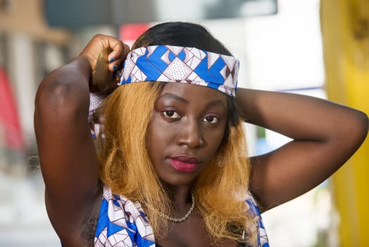 african woman wearing a nice blue scarf on the head outside