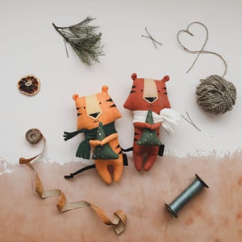 Christmas composition with a tiger toy, symbol of new 2022, a gift, fir tree branches and decorations. Christmas, winter, New year concept. Flat lay, top view.