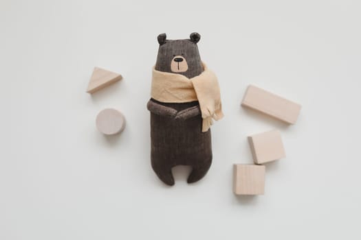 Wooden toys, blocks, handmade toy bear on white background. Toys for kindergarten, preschool or daycare. Eco-friendly colored wooden educational toys based on the Montessori method. Copy space