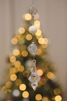 Christmas and New years eve Background. Close up of balls on christmas tree. Bokeh garlands in the background. New Year concept. Decorated Christmas tree on blurred, sparkling and fairy background