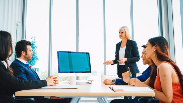 Business people in the conference room with green screen chroma key TV or computer on the office table. Diverse group of businessman and businesswoman in meeting on video conference call . Jivy