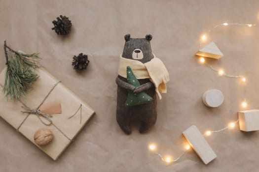 Christmas composition. Toy Teddy Bear, a gift, fir tree branches and decorations. Christmas, winter, new year concept. Flat lay, top view, copy space.