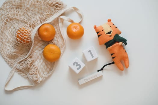 Christmas or New Year composition with tangerines and tiger toy - symbol of 2022.