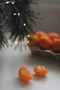 Christmas background with fir tree branches and tangerines. Merry Christmas and Happy New Year Greeting Card. Copy space. Top view. High quality photo