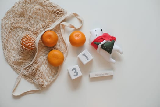 Christmas or New Year composition with tangerines and toy white bear.