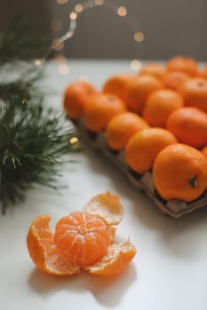 Christmas background with fir tree branches and tangerines. Merry Christmas and Happy New Year Greeting Card. Copy space. Top view. High quality photo