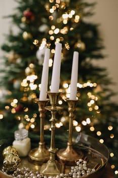 Christmas candles and ornaments over dark background with lights. High quality photo