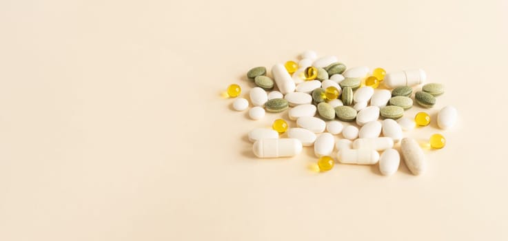 Banner Colorful Pile of Scattered Capsules, Pills, Tablets on Beige Background. Various Medical Supplements, Vitamins or Drug Pharmaceutical Concept. Copy Space For Text. Health Insurance, Horizontal