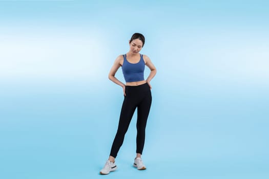 Full body asian woman in sportswear portrait, smiling and posing cheerful gesture. Workout training with attractive girl engage in her pursuit of healthy lifestyle. Isolated background Vigorous