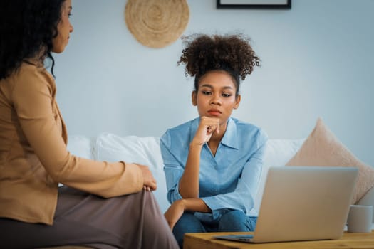Sad PTSD woman patient in crucial therapy for mental health with psychologist, depression or grief after life failure. Frustrated trauma young woman talking to a psychologist about emotion in clinic