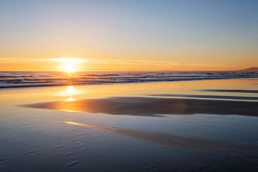 Atlantic ocean sunset with surging waves at Fonte da Telha beach, Costa da Caparica, Portugal