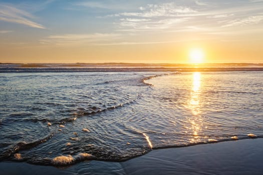 Atlantic ocean sunset with surging waves at Fonte da Telha beach, Costa da Caparica, Portugal