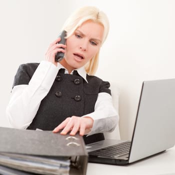 Young businesswoman sitting at desk with computer