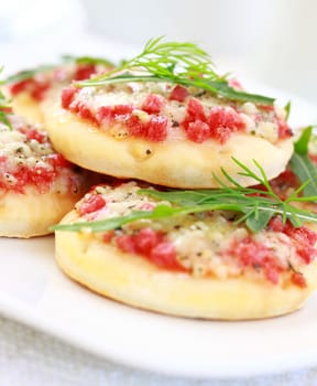Small cakes with ham and cheese as appetizer