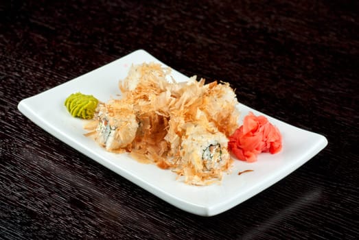 Sushi rolls of rice, nori, cream cheese, avocado, smoked salmon,cucumber and cuts of tuna