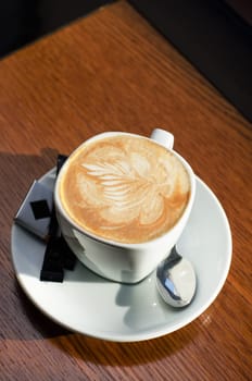 Cappuccino coffee cup closeup at the table