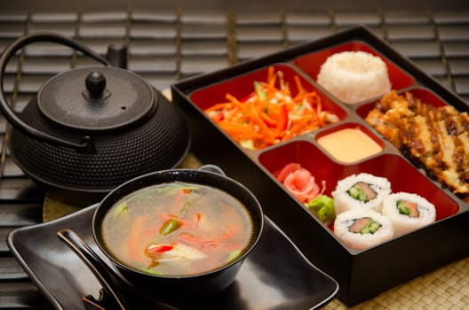 Sushi lunch with soup salad tea and sauce