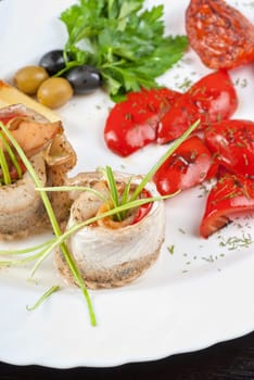 fillet of pikeperch stuffed with trout fish with baked pepper, tomato and leek