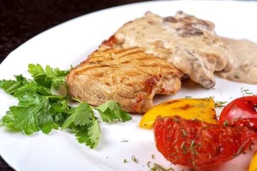 pork steak with mushroom sauce and grilled vegetables