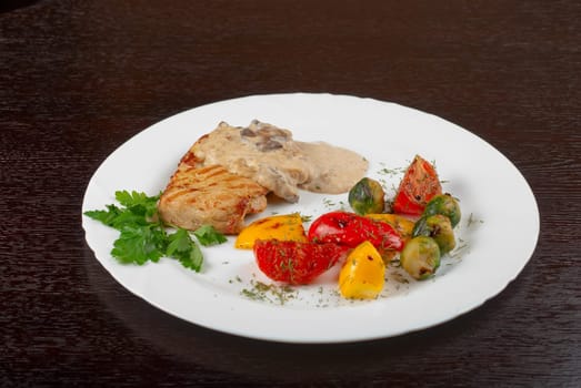 pork steak with mushroom sauce and grilled vegetables