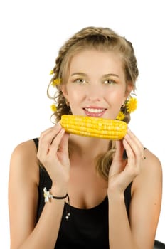 Close-up portrait of young beauty woman eating corn-cob on a white