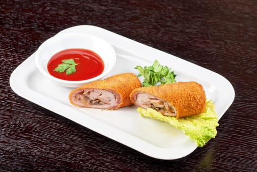 Closeup of rolls from pork meat, champignon mushroom, cheese and sauce