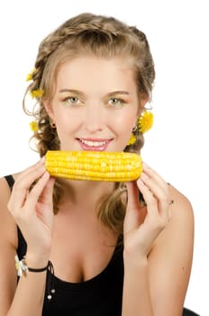 Close-up portrait of young beauty woman eating corn-cob on a white