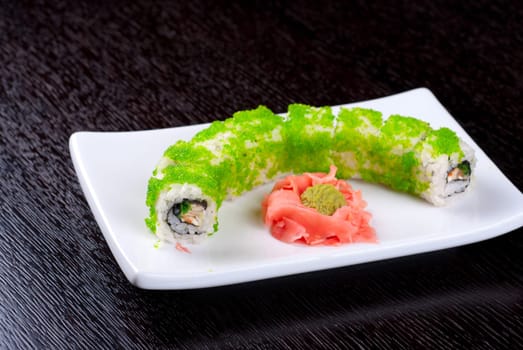 Sushi rolls made of salmon, avocado, flying fish roe - tobiko caviar and philadelphia cheese
