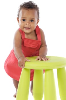 Toddler playing with a chair a over white background