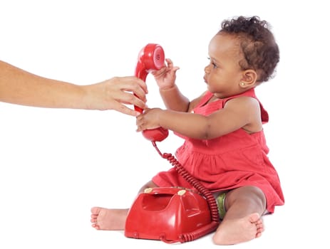 Cute baby girl holding a red phone