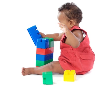 Adorable baby girl playing with building blocks