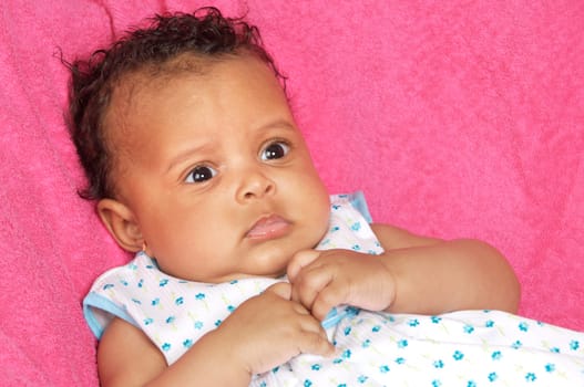 lovely and beautiful baby on a pink towel