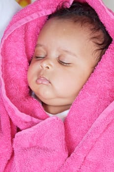 adorable sleepy girl a over pink background