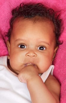 lovely and beautiful baby on a pink towel