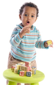 Girl playing with small pieces a over white background