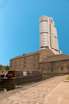 A Tower Block overlooking Canal side Buildings and a barge